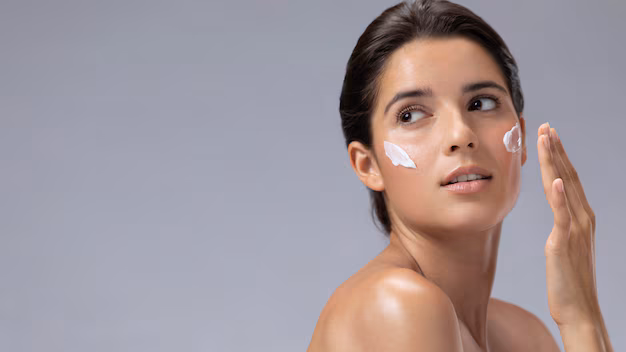 woman applying snail mucin face wash skincare to her face