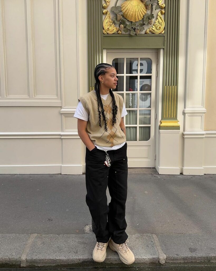 gender-fluid fashion model wearing sweater vest with white T short and cargo pants