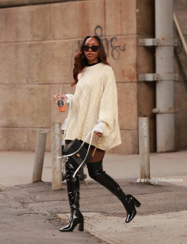 Model in white oversized sweater and thigh high boots 