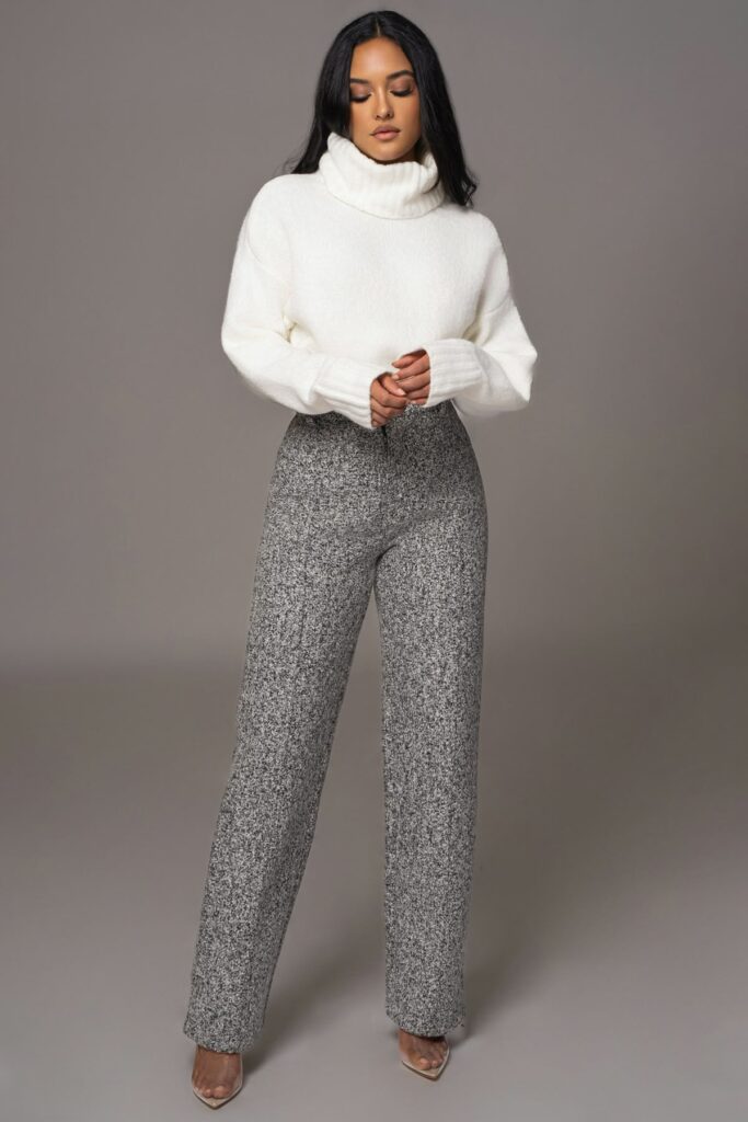 model in white heavy neck sweater  with tweed slacks and brown heels 