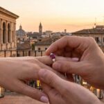 two hands with ruby engagement rings