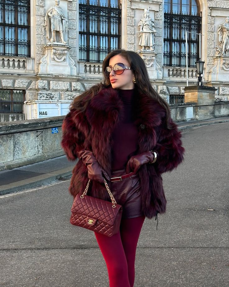Model wearing deep burgundy faux fur coat 