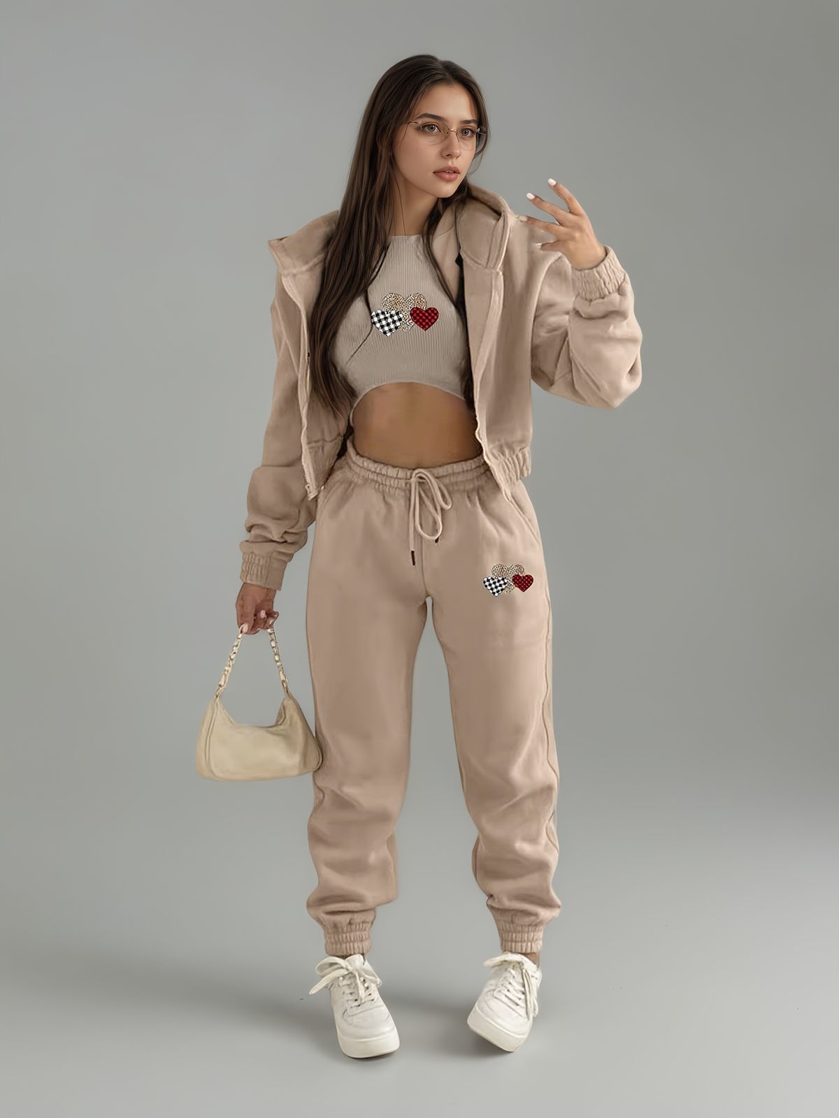 model in matching swaet pants and crop top with jacket 