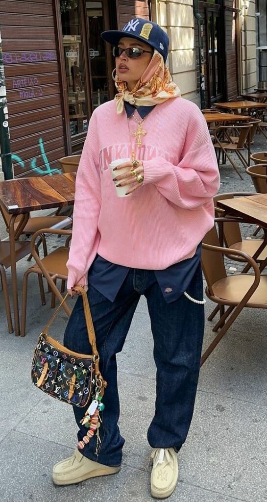 Model wearing pink sweater with pink bandana scarf