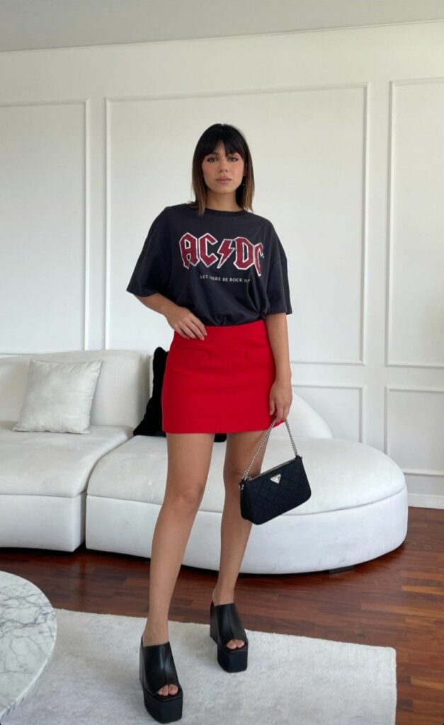 Model in graphic conert Tee shirt and red mini skirt 