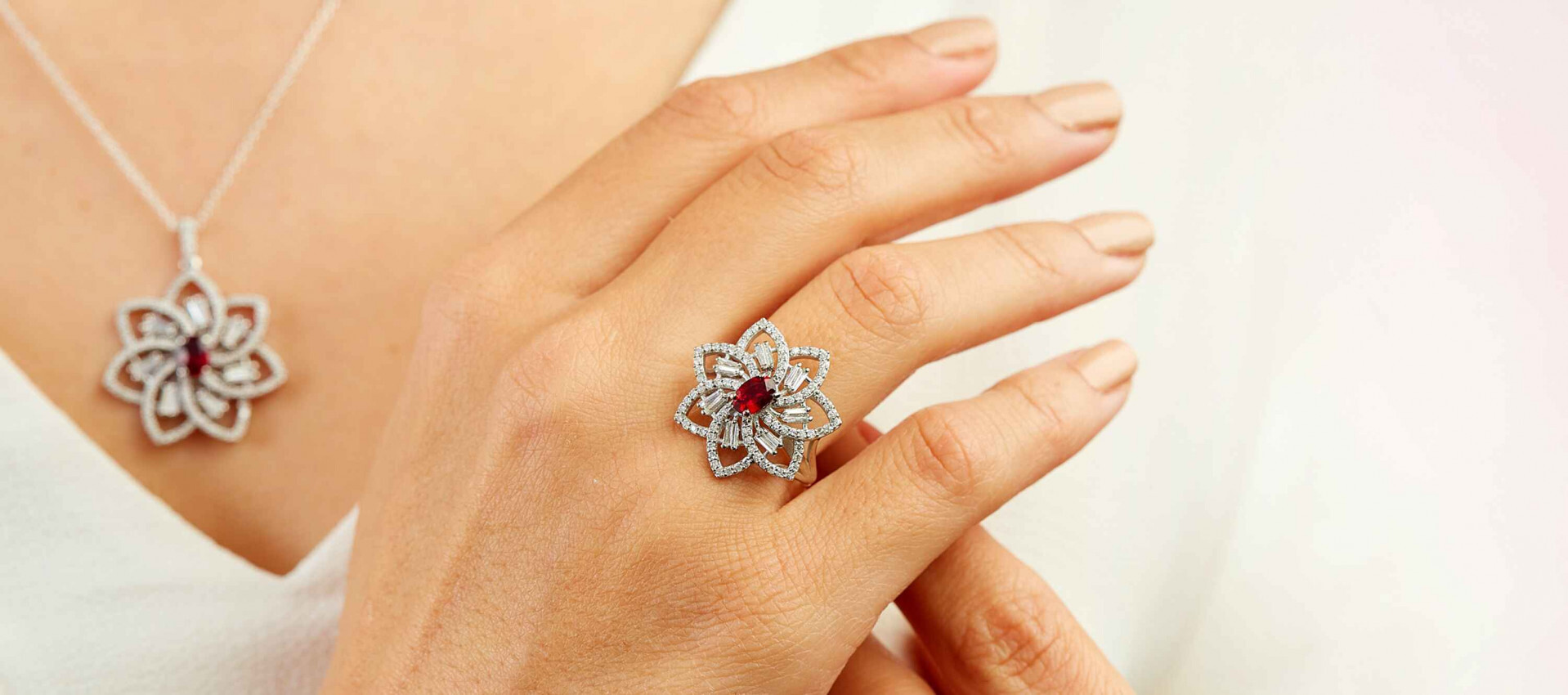 a woman wearing a Ruby Ring and a ruby necklace