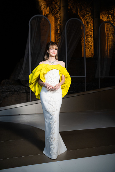Blackpink Lisa dressed in a two-tone embroidered which included a neon yellow big draped top and a flowing white embroidered maxi skirt.