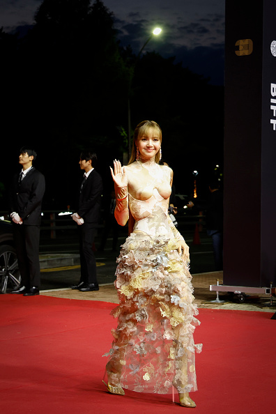 Blackpink Lisa made her appearance at the 30th Busan International Film Festival in a floor-length turtleneck dress influenced by Maison Margiela