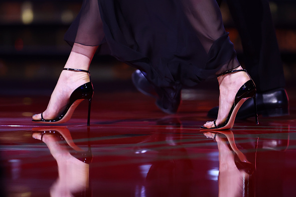 Actress Anya Taylor-Joy arrives on stage at the 2025 Marrakech International Film Festival Closing Ceremony wearing a Tom Ford lace dress and ankle-strap high-heeled sandals.