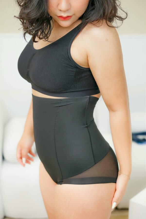model wearing a black shapewear