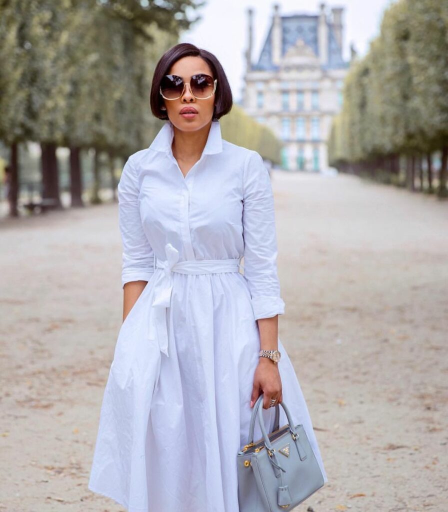 model in white dress with sunglasses 