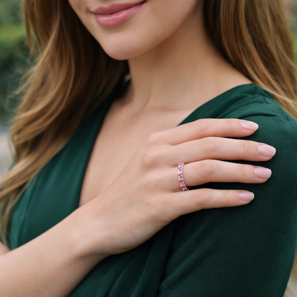 Models hand wearing pink sapphire ring