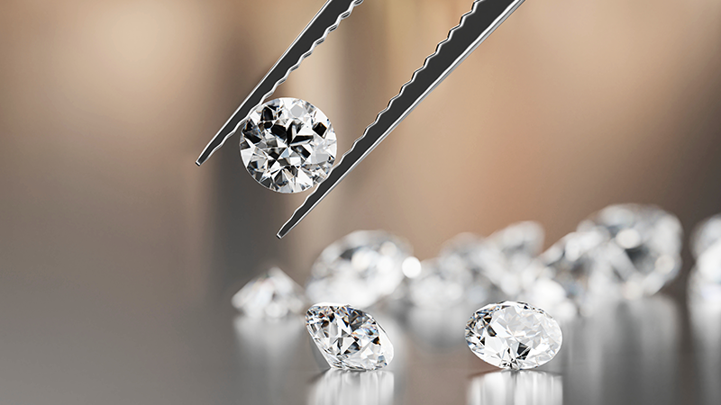 lab created diamond in tweezers