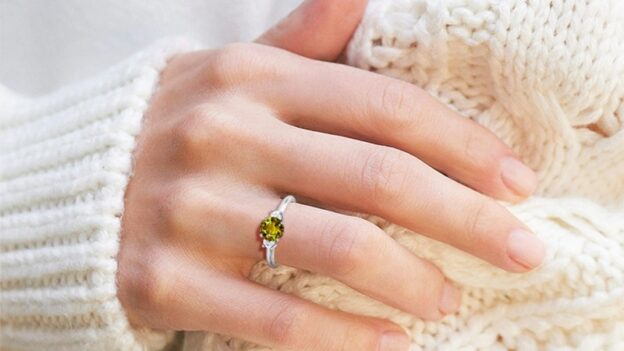 Hand wearing yellow gemstone ring
