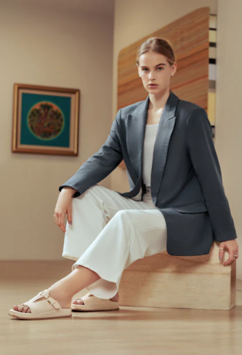model in blue blazer, white slacks and white sandals 