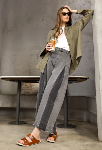 Model in green shirt gray slacks and brown leather women footwear sandals 