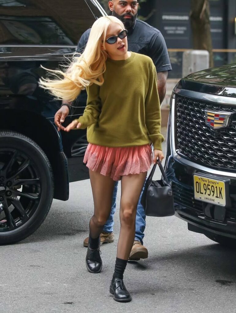 Rosé in green sweater and pink mini skirt 