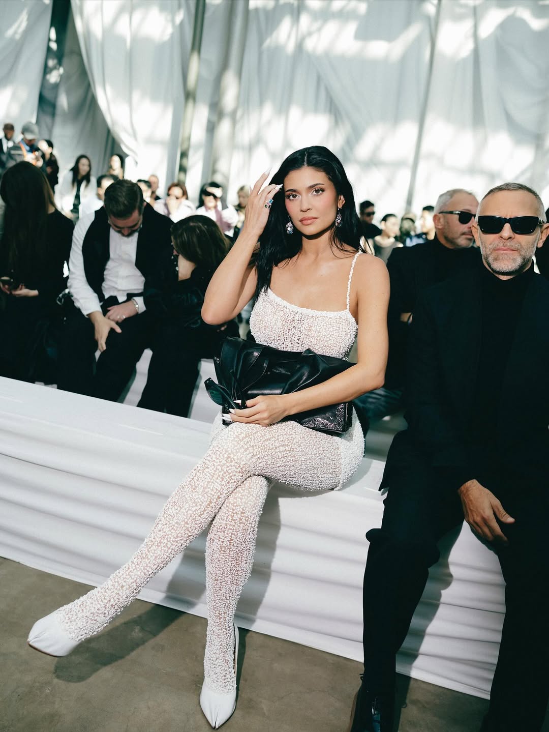 Kylie Jenner Stuns in a White Sheer Lace Dress and Tights at the Maison Margiela Spring/Summer 2026 Show