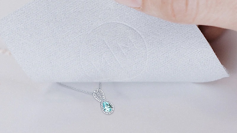 aquamarine necklace on bedspread