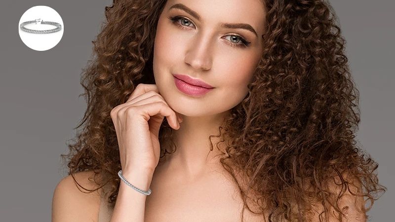 a woman wearing a white gold diamond bracelet