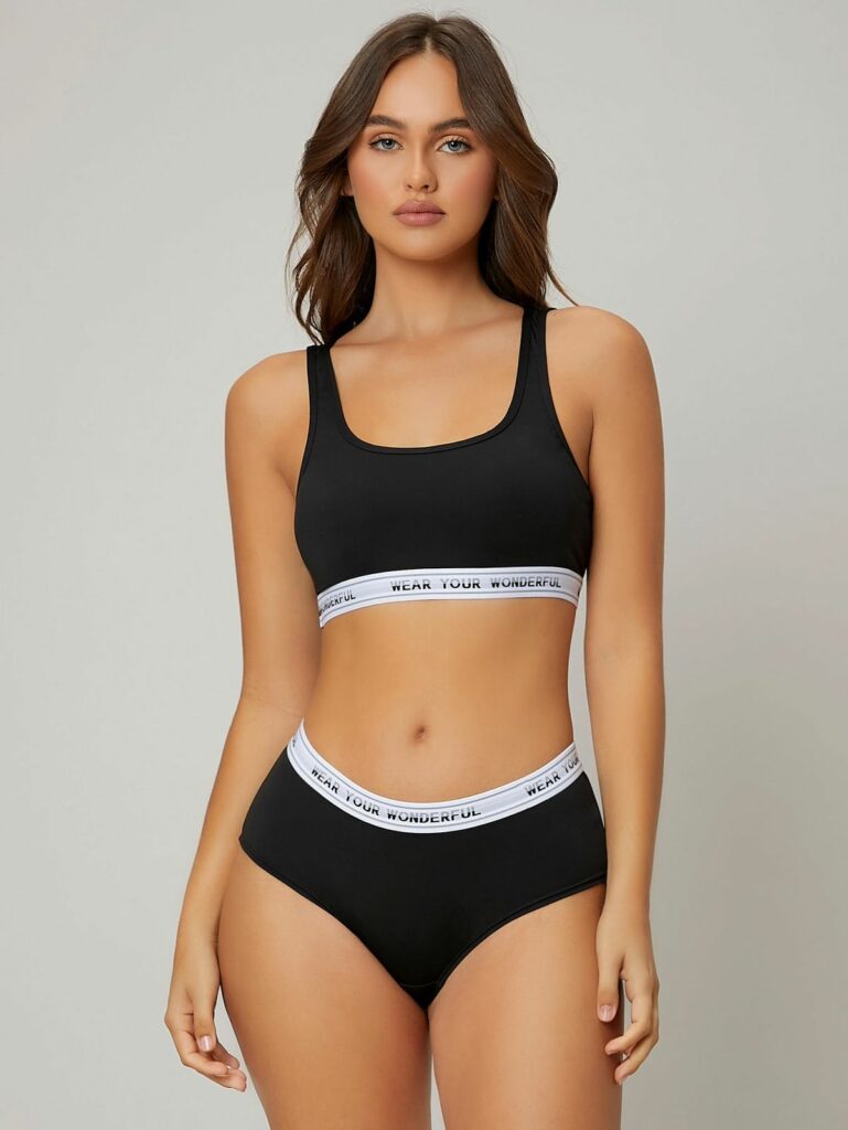 Model wearing black sports bra and brief panties