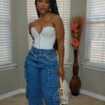 Model in white Corset top with jeans