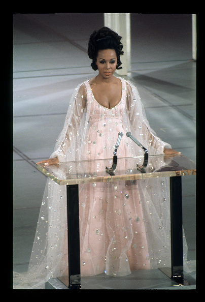 Diahann Carroll donned an embroidered translucent tulle overlay cape gown at the 1969 Academy Awards, which Alberta Ferretti replicated for Ariana Grande’s performance at the 2026 Critics' Choice Awards.