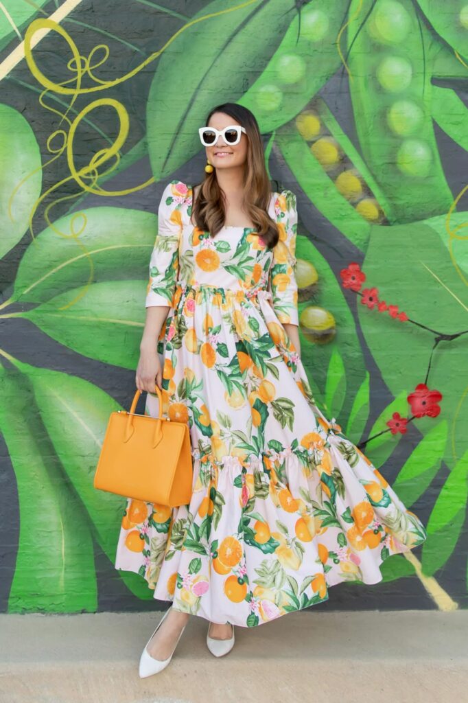 Model in sunglasses with white foloral printed maxi dress