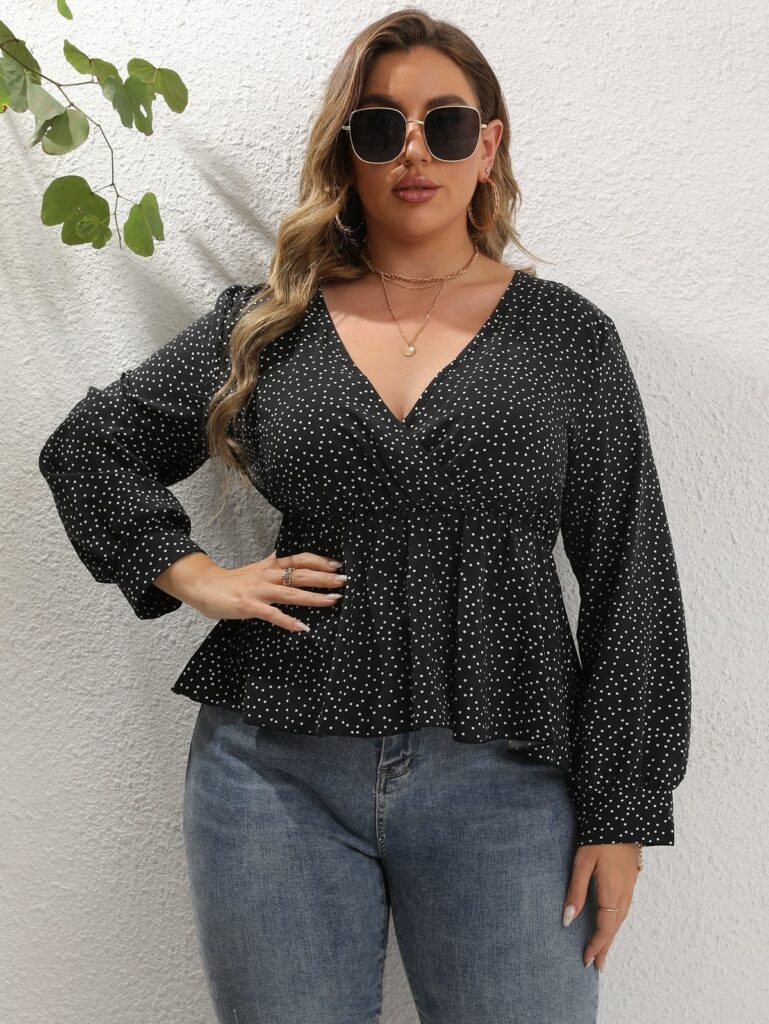 Model in black peplum top with micro polka dots and blue jeans 