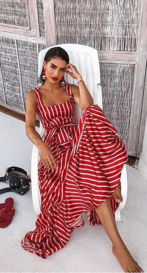 Model in rad maxidress with white horizontal pin stripes 
