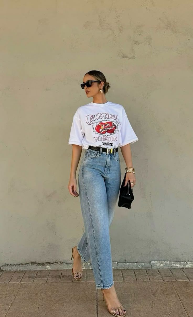 White oversized printed T-shirts paired wth denim jeans for a preppy look