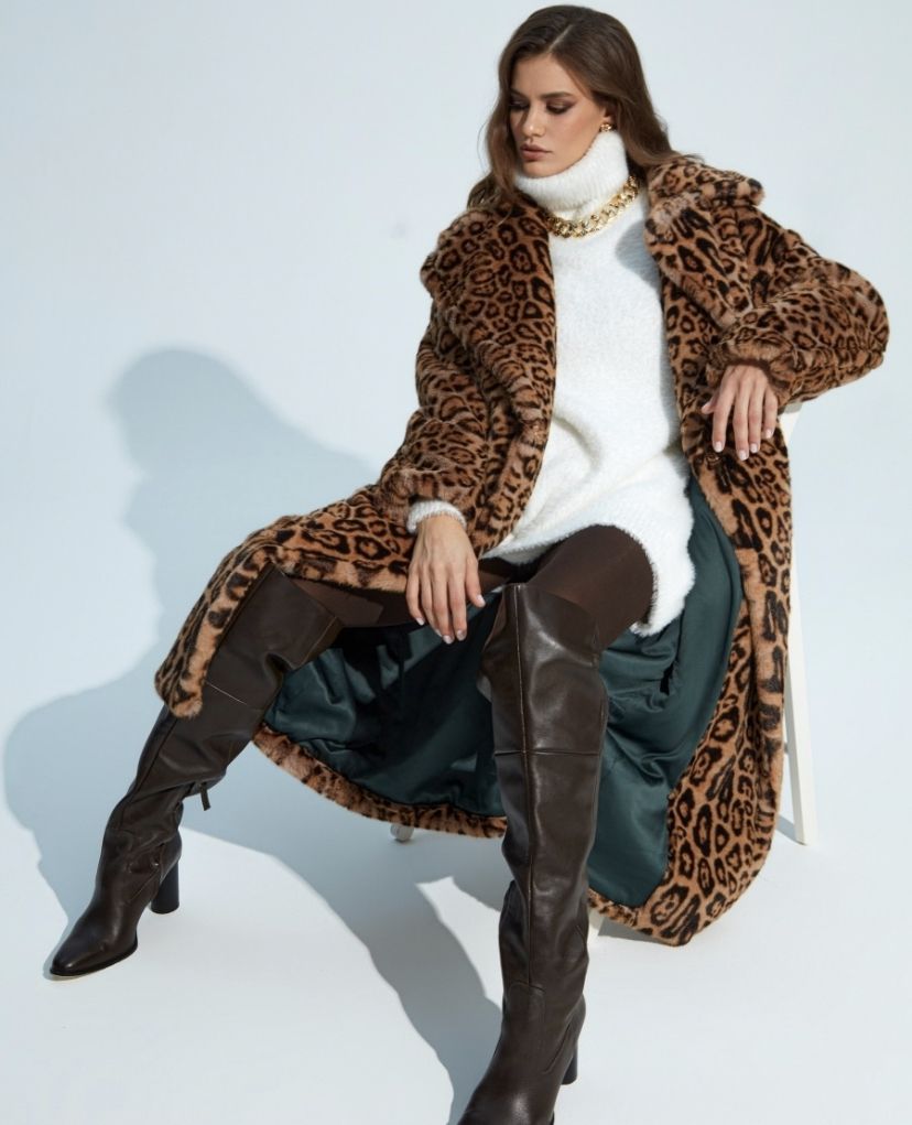 Model in white sweater dress and full lenght leopard print faux fur coat
