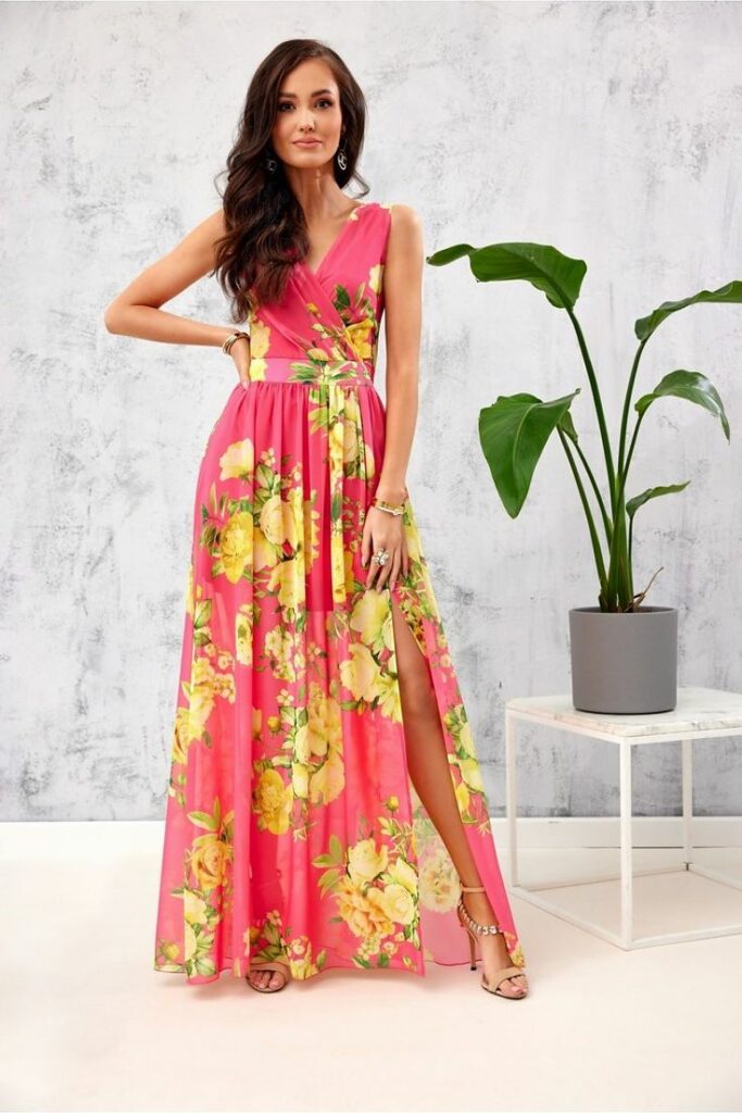 Model in pink floral wrap around maxi dress to demonstrste maxi dresses 