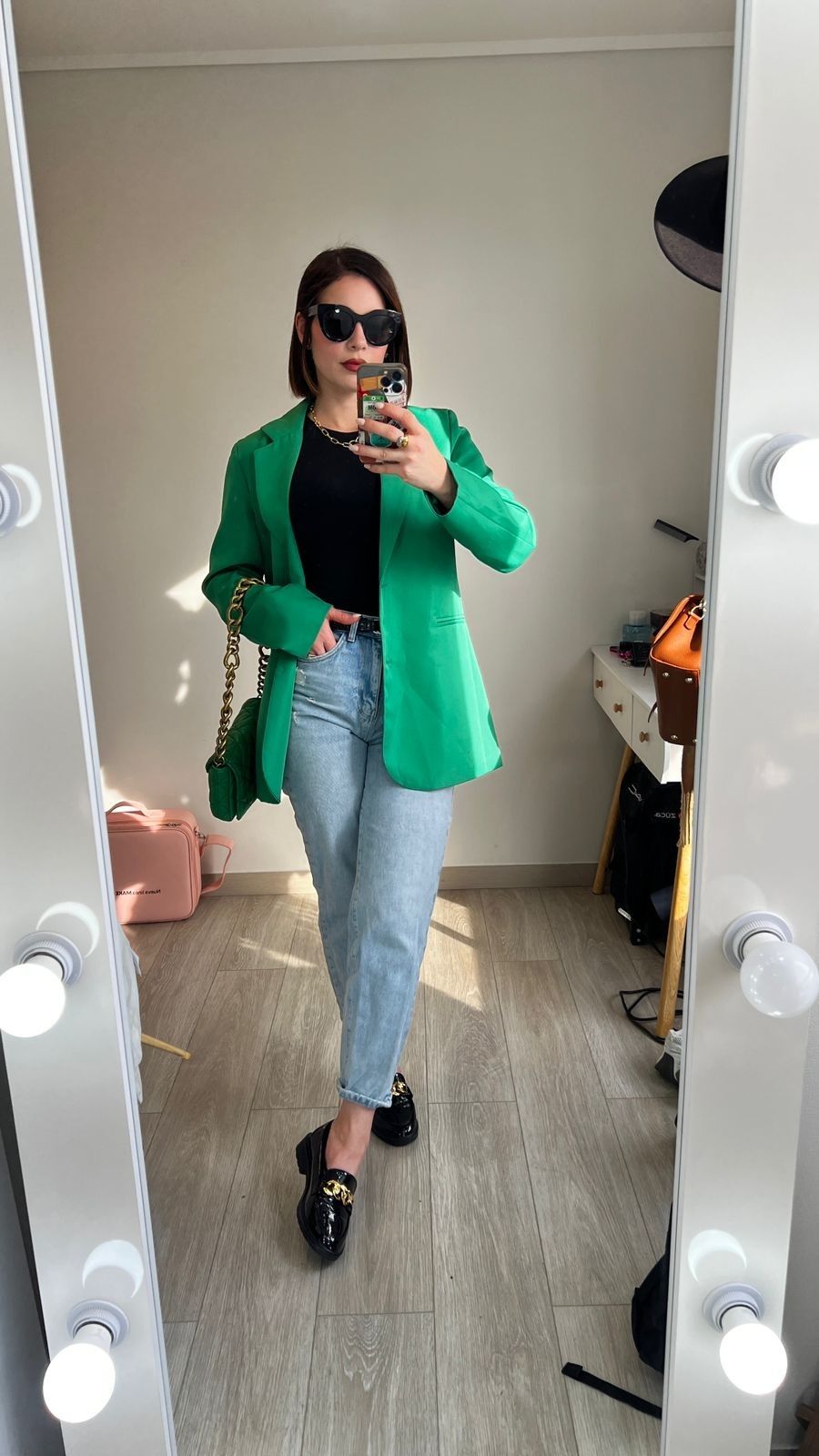 green blazer with denim jeans