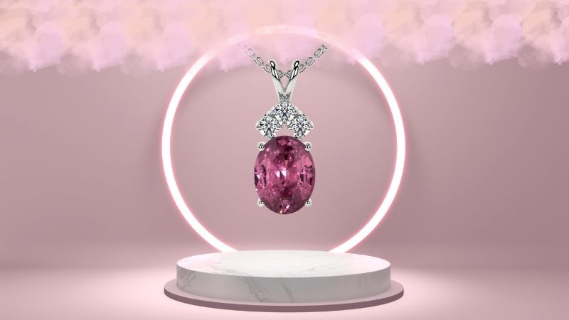 Pink gemstones pendant necklace in a hanging position containing a pink diamond