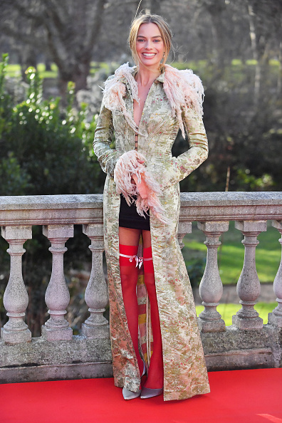 Margot Robbie attends the “Wuthering Heights” photocall during the “Wuthering Heights” promotion tour in London, wearing a vintage John Galliano spring/summer 1992 floral brocade-style coat embellished with fluffy fur along the collar and cuffs, paired with a short skirt, thigh-high stockings, and custom Manolo Blahnik Carolyne slingback pumps.