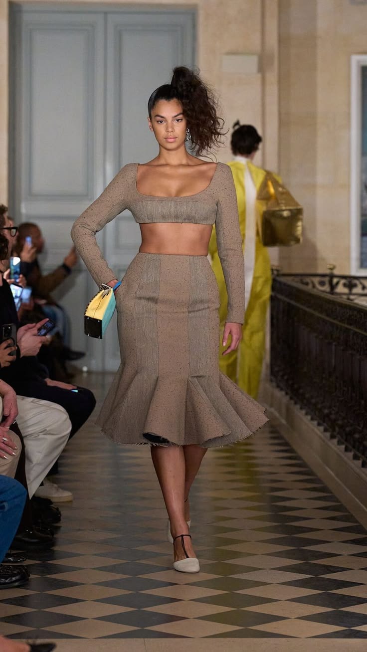0c71f84153c189e5f61f5b99879fee8d | Fashonation Emeline Hoareau walks the Jacquemus “Le Palmier” Fall/Winter 2026 collection fashion show clad in a long-sleeved square-neck crop top and flounced midi skirt combo.