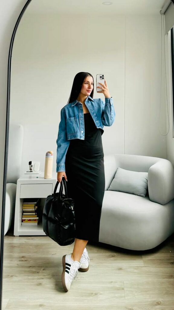 Model showing how to style a bodycon dress in black with white sneakers