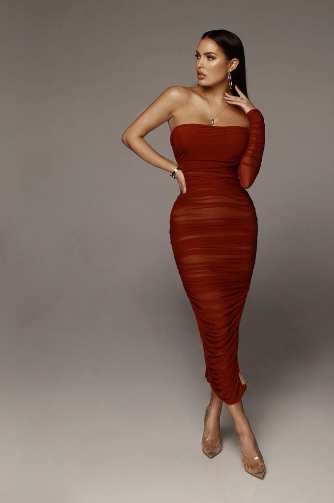 Model in red sheer Ruched bodycon dress