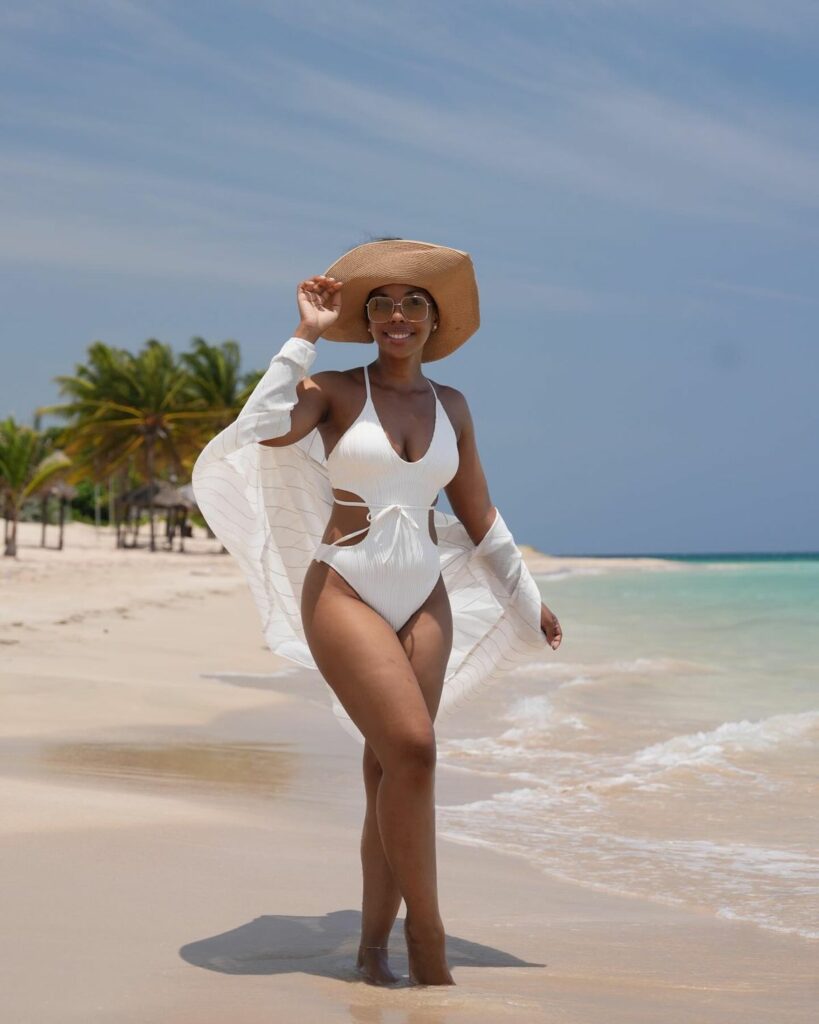 Model in white monokini bathing suit