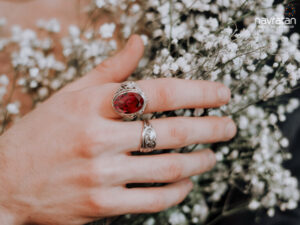 hand with a garnet January birthstone ring