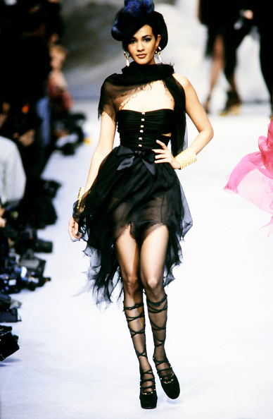 During the presentation of the Chanel Spring/Summer Haute Couture 1992-1993 collection, a model elegantly walked the runway displaying a strapless tulle midi dress paired with lace-up platform pumps.