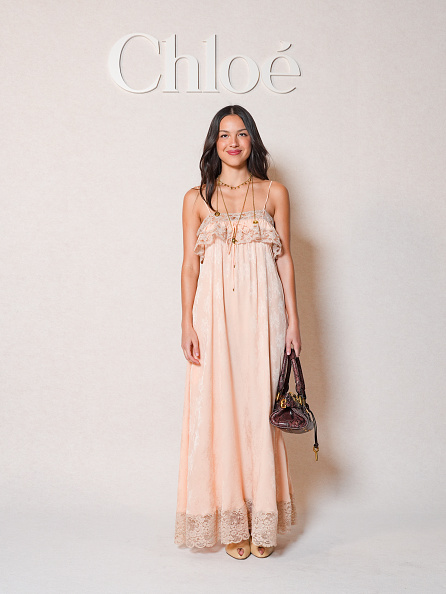 Olivia Rodrigo attended the Chloé Womenswear Fall/Winter 2026-2027 show at the Maison de l’UNESCO on day 4 of Paris Fashion Week, dressed in a pale pink Chloé bohemian lace maxi dress.