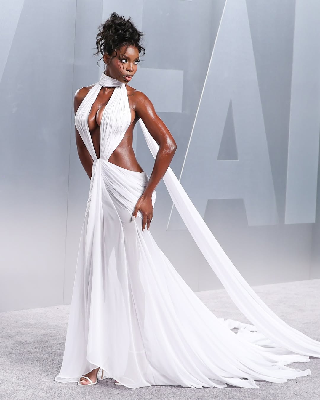 Olandria Carthen was photographed at the 2026 Vanity Fair Oscar Party in a Pajtim Raci Atelier cutout dress and Azature fine jewelry.