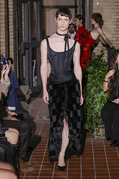 Keke Palmer graced the 2026 Time100 Gala in a Wiederhoeft scoop-neck midi dress from the “Lost Works” Spring/Summer 2026 collection, featuring a black matte satin Venus corset and a thigh-high slit tulip skirt made of black faux fur with scalloped Chantilly lace embellishments.