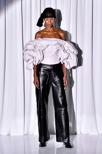 Vaquera’s Spring/Summer 2026/2027 ready-to-wear collection premiered at Paris Fashion Week, with an off-the-shoulder puff-sleeve corset top and high-waisted wide-leg leather pants.