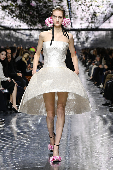 Frauke Nijs appeared on the runway wearing a strapless gown featuring a precisely tailored bodice and a bell-shaped mini skirt during the Dior Haute Couture Spring/Summer 2026 ready-to-wear collection show.