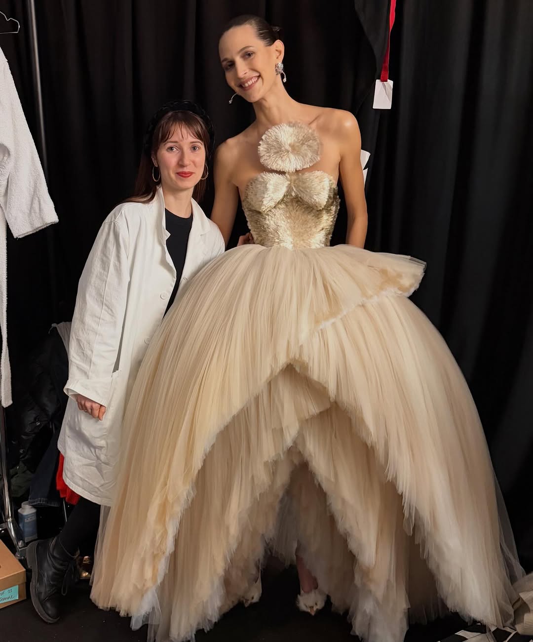 During Paris Fashion Week, Jeanne Cadieu wore the Defying Gravity ivory tulle gown with a sfumato effect and scissor hem.