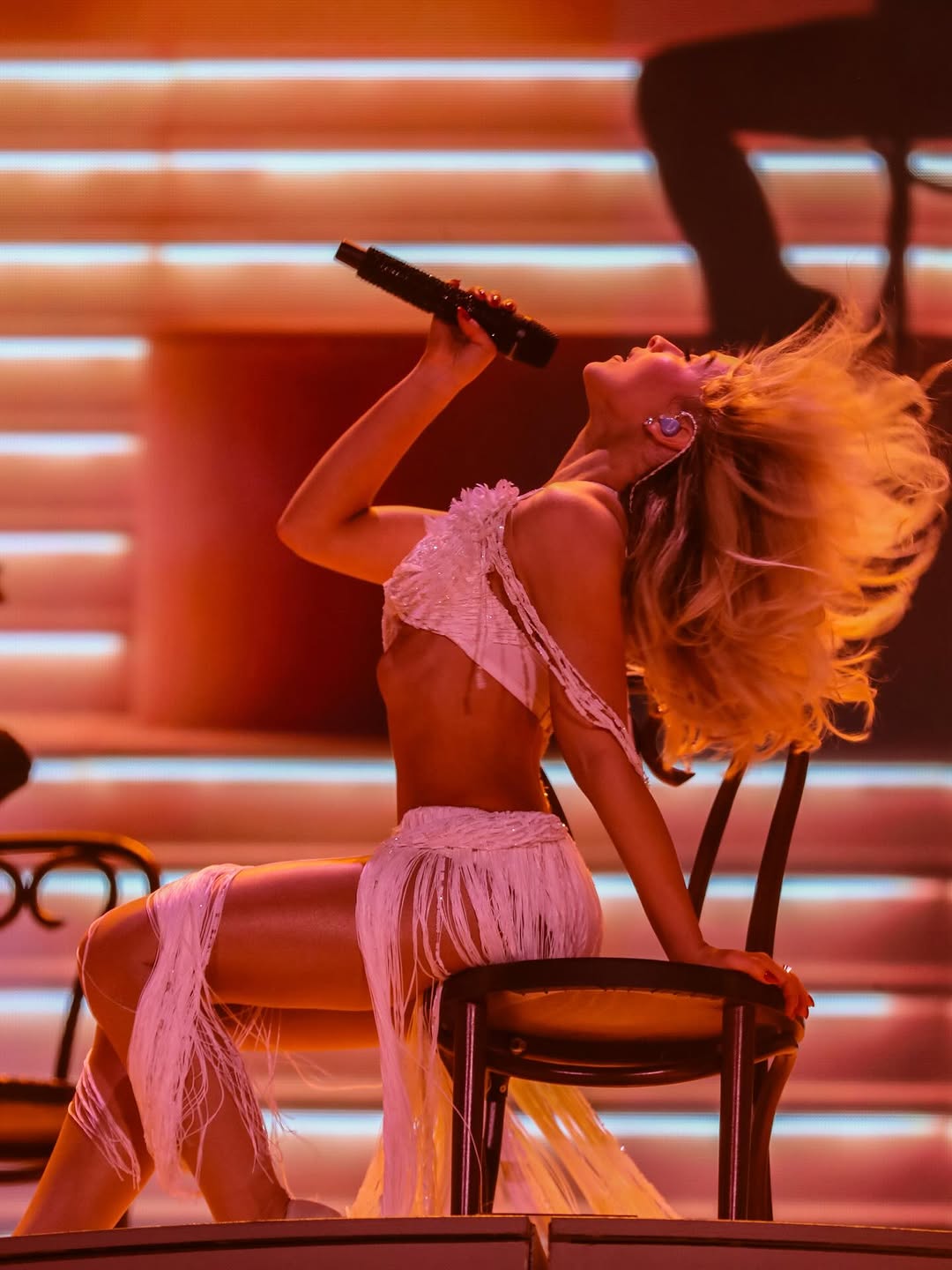 Sabrina Carpenter delivered a spectacular look in a white beaded fringed Dior two-piece bustier bra top and wrap maxi skirt set, paired with Christian Louboutin pumps.