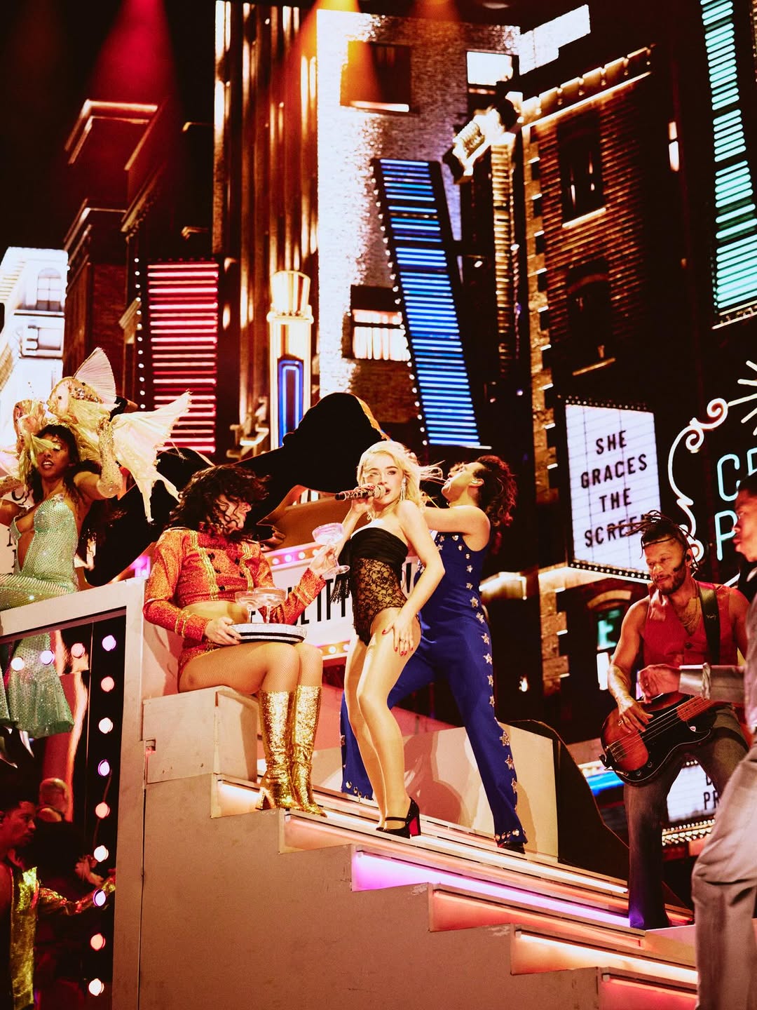 Sabrina finished her look with Christian Louboutin Top Street black patent leather bedazzled Mary Jane pumps.